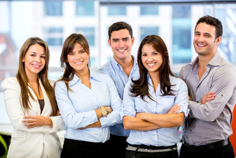 Three women and two men in smart business clothes