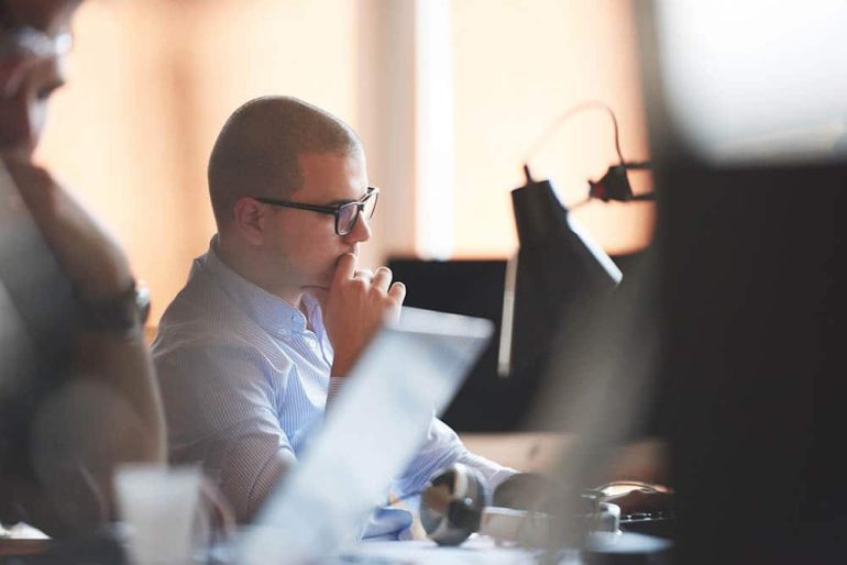 Man working on a Translation Management System in an office